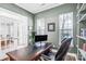 Comfortable home office featuring a large desk, natural light, and a view to the exterior at 10509 Serape Rd, Charlotte, NC 28277