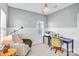 A cozy home office featuring light blue walls, a desk, a chair, and stylish lighting at 10509 Serape Rd, Charlotte, NC 28277
