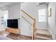 Bright staircase showcasing a modern design with hardwood railings and natural light at 10509 Serape Rd, Charlotte, NC 28277