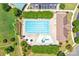 An aerial shot of a swimming pool with a parking area, lounge chairs, umbrellas, and a ' area at 10509 Serape Rd, Charlotte, NC 28277