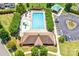 Aerial view of a community pool with a play area, lounge chairs, and parking at 10509 Serape Rd, Charlotte, NC 28277