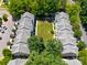 Aerial view of community with well-maintained lawn, mature trees, and gray rooftops at 11021 Dundarrach Ln # 40, Charlotte, NC 28277