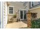 Back patio area with natural stacked stone accent, neutral siding and small seating area at 11021 Dundarrach Ln # 40, Charlotte, NC 28277