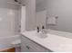 Bright bathroom features a shower-tub combo, white fixtures, and a vanity at 11021 Dundarrach Ln # 40, Charlotte, NC 28277