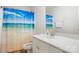 Bathroom with a vibrant shower curtain and a white vanity with ample counter space at 11021 Dundarrach Ln # 40, Charlotte, NC 28277