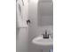 A well-lit powder room featuring white walls, a towel, and updated fixtures at 11021 Dundarrach Ln # 40, Charlotte, NC 28277