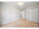 A spacious bedroom with neutral carpet, ceiling fan and a double door closet at 11021 Dundarrach Ln # 40, Charlotte, NC 28277