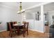Open-concept dining room offering wood floors, chandelier, and views to other living areas at 11021 Dundarrach Ln # 40, Charlotte, NC 28277