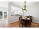 Dining room with wood floors, chandelier and an open view to modern kitchen at 11021 Dundarrach Ln # 40, Charlotte, NC 28277