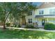 Well-manicured townhome exteriors, framed by mature shade trees and a lush green lawn at 11021 Dundarrach Ln # 40, Charlotte, NC 28277