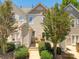 Charming home features a front porch, a stone entry, and well-maintained landscaping at 11021 Dundarrach Ln # 40, Charlotte, NC 28277
