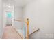 Hallway with stairs leading up, carpet, and a door to another room with a window at 11021 Dundarrach Ln # 40, Charlotte, NC 28277