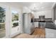 Bright kitchen with stainless steel appliances, white cabinets and an adjoining backdoor at 11021 Dundarrach Ln # 40, Charlotte, NC 28277