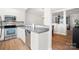 Modern kitchen with white cabinets, stainless steel appliances, and open view to dining room at 11021 Dundarrach Ln # 40, Charlotte, NC 28277