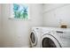Laundry room with side-by-side washer and dryer, window for natural light, and wire shelf at 11021 Dundarrach Ln # 40, Charlotte, NC 28277