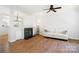 Bright living room featuring a fireplace, ceiling fan, hardwood floors, and a white sofa at 11021 Dundarrach Ln # 40, Charlotte, NC 28277