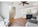 Bright living room featuring a fireplace, hardwood floors, a staircase, and a white sofa at 11021 Dundarrach Ln # 40, Charlotte, NC 28277