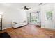 Bright living room featuring a ceiling fan, hardwood floors, a sofa, and a door leading outside at 11021 Dundarrach Ln # 40, Charlotte, NC 28277