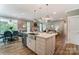 Spacious kitchen with a large island, stainless steel sink, and open view to the dining and living areas at 111 Longwood Rd # 59, Mooresville, NC 28115