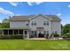 Spacious backyard with patio, screened porch, and well-maintained lawn at 112 Steeplechase Ave, Mooresville, NC 28117