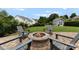Backyard with a brick patio, fire pit, seating, and a well-maintained lawn at 112 Steeplechase Ave, Mooresville, NC 28117