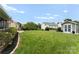 Expansive backyard featuring lush green lawn, garden beds, and a storage shed at 112 Steeplechase Ave, Mooresville, NC 28117