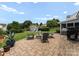 Spacious backyard with patio, fire pit, shed, and well-manicured lawn at 112 Steeplechase Ave, Mooresville, NC 28117