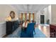 Formal dining room with a tray ceiling, a long table with seating, stylish decor and natural light at 112 Steeplechase Ave, Mooresville, NC 28117
