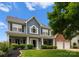 Charming two-story home featuring a manicured lawn and a welcoming front porch at 112 Steeplechase Ave, Mooresville, NC 28117