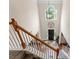 A grand foyer featuring a soaring ceiling, statement chandelier, and staircase with wood railing and neutral carpet at 112 Steeplechase Ave, Mooresville, NC 28117