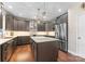 Modern kitchen with stainless steel appliances, dark wood cabinets, a large island and pendant lighting at 112 Steeplechase Ave, Mooresville, NC 28117