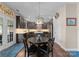 Eat-in kitchen boasts dark wood cabinets, stainless steel appliances, a center island and french doors to the yard at 112 Steeplechase Ave, Mooresville, NC 28117