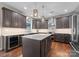 Well-appointed kitchen features stainless steel appliances, a large island with a marble countertop and stylish lighting at 112 Steeplechase Ave, Mooresville, NC 28117