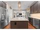 Spacious kitchen with stainless steel appliances, a marble-topped island, and a view into the living room at 112 Steeplechase Ave, Mooresville, NC 28117
