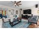 Cozy living room featuring a ceiling fan, large TV, a blue patterned rug and comfortable seating at 112 Steeplechase Ave, Mooresville, NC 28117