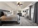 Spacious main bedroom boasts a tray ceiling, plush carpet, sitting area, and an en-suite bath at 112 Steeplechase Ave, Mooresville, NC 28117