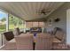Relaxing outdoor patio featuring comfortable seating, a ceiling fan, and a covered roof at 112 Steeplechase Ave, Mooresville, NC 28117