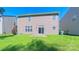 Well-maintained backyard featuring a sliding glass door, a lush green lawn, and a concrete patio for outdoor enjoyment at 11514 Hattie Little St, Charlotte, NC 28269