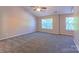 Spacious bedroom with large windows providing ample natural light and plush carpeting at 11514 Hattie Little St, Charlotte, NC 28269