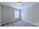 Bedroom with neutral walls, carpet, and a window bringing in natural light at 11514 Hattie Little St, Charlotte, NC 28269