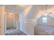 Upstairs hallway leading to a carpeted room with a ceiling fan and window at 11514 Hattie Little St, Charlotte, NC 28269