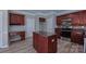 Well-lit kitchen featuring stainless appliances, kitchen island, and dark wood cabinets at 11514 Hattie Little St, Charlotte, NC 28269