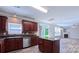 Open concept kitchen with granite countertops, stainless appliances, and a view into living area at 11514 Hattie Little St, Charlotte, NC 28269