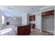 Open kitchen with adjacent living area featuring a fireplace and plenty of natural light at 11514 Hattie Little St, Charlotte, NC 28269