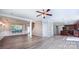 Open concept living room with luxury flooring, kitchen view, and elegant ceiling detail at 11514 Hattie Little St, Charlotte, NC 28269