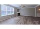 Cozy living room with a fireplace, ceiling fan, and large windows at 11514 Hattie Little St, Charlotte, NC 28269