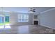 Cozy living room with a fireplace, ceiling fan, and large windows at 11514 Hattie Little St, Charlotte, NC 28269