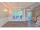 Bright living room featuring elegant lighting, crown molding, and wood floors at 11514 Hattie Little St, Charlotte, NC 28269