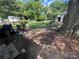 Backyard with green grass, trees, and storage shed at 119 Hemlock Ave, Kannapolis, NC 28081