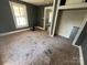 View of bedroom with carpet floors, grey walls, and closet entrance at 119 Hemlock Ave, Kannapolis, NC 28081